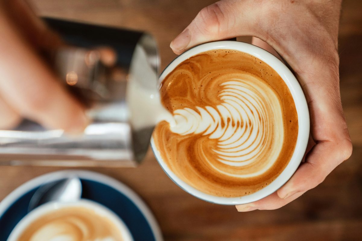 Barista pouring latte art at a café in Methven.